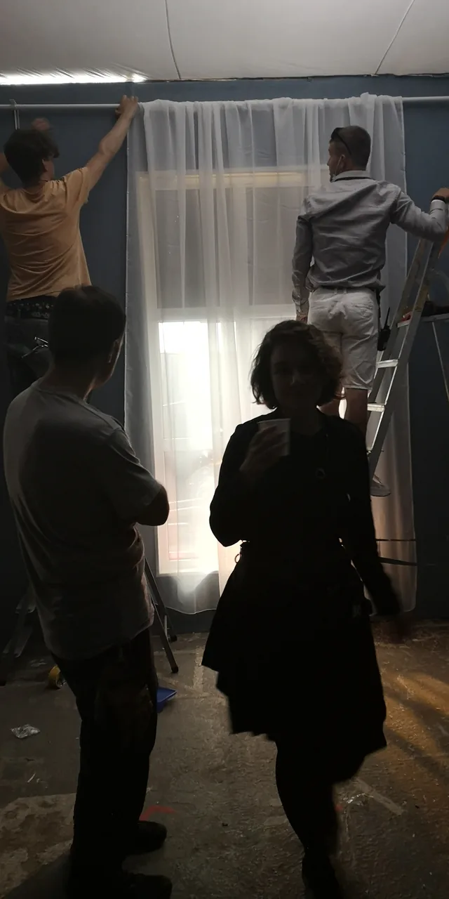 Preparing the window and curtains on set