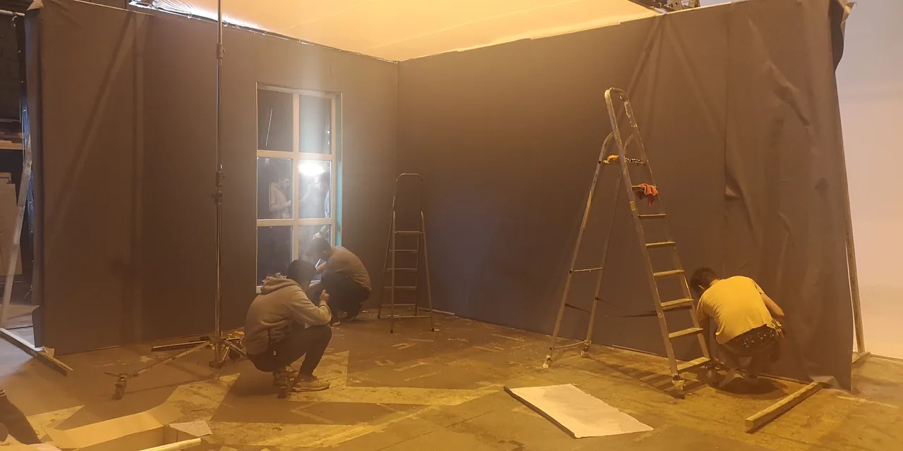 A wide view of the window set and crew at work